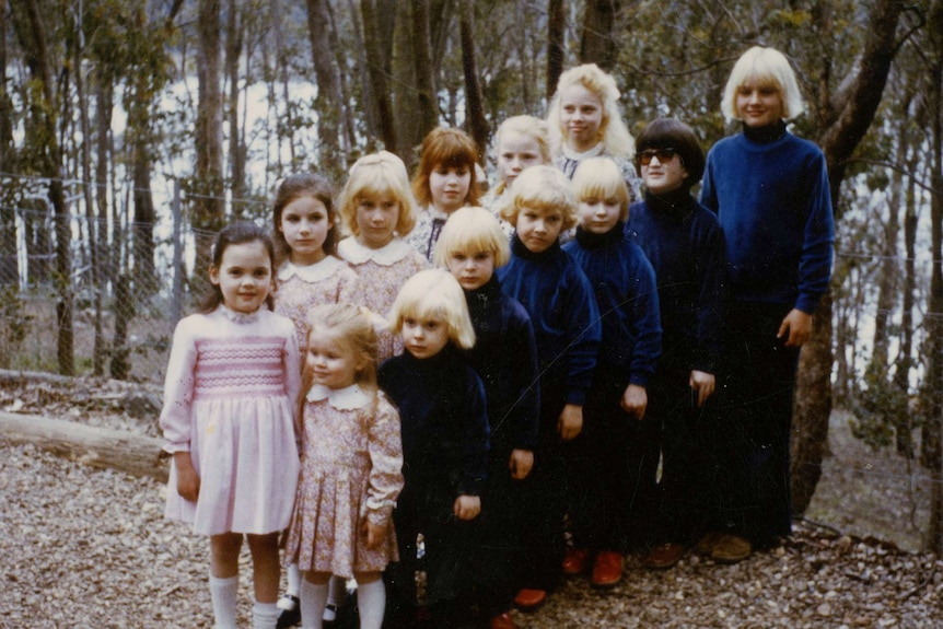 Children in The Family line up and look at the camera.