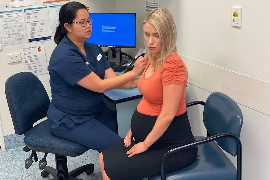 A nurse giving a pregnant woman a vaccination shot