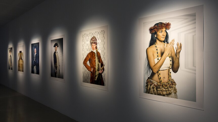 Installation view of Cinemania exhibition featuring large photographic portraits of actors portraying 18th century figures.