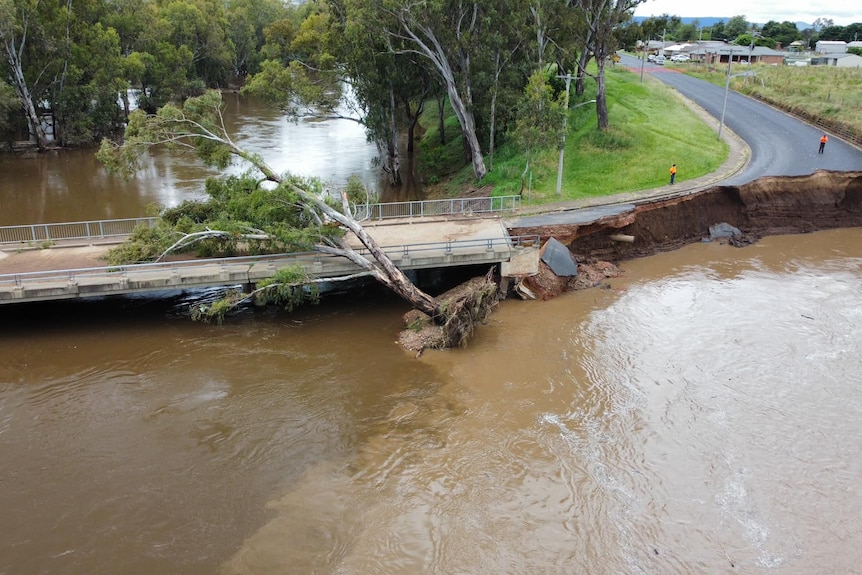 a road inundated in floowater ends in a cliff