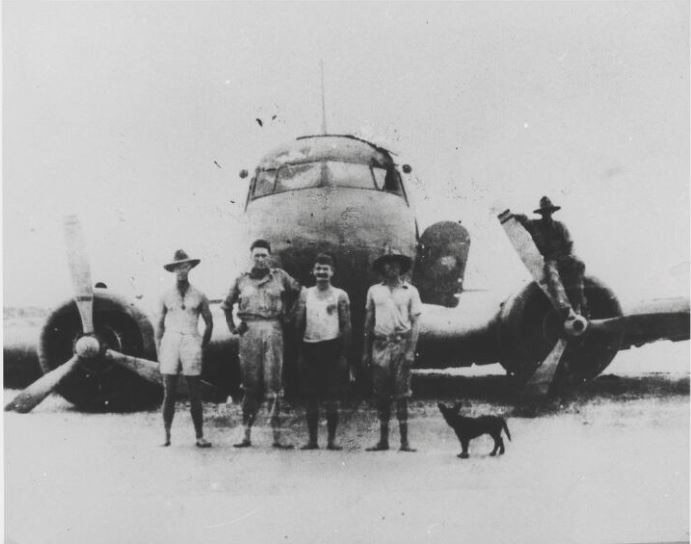 Investigating party standing in from of the crashed Netherlands East Indies KLM Dakota DC-3