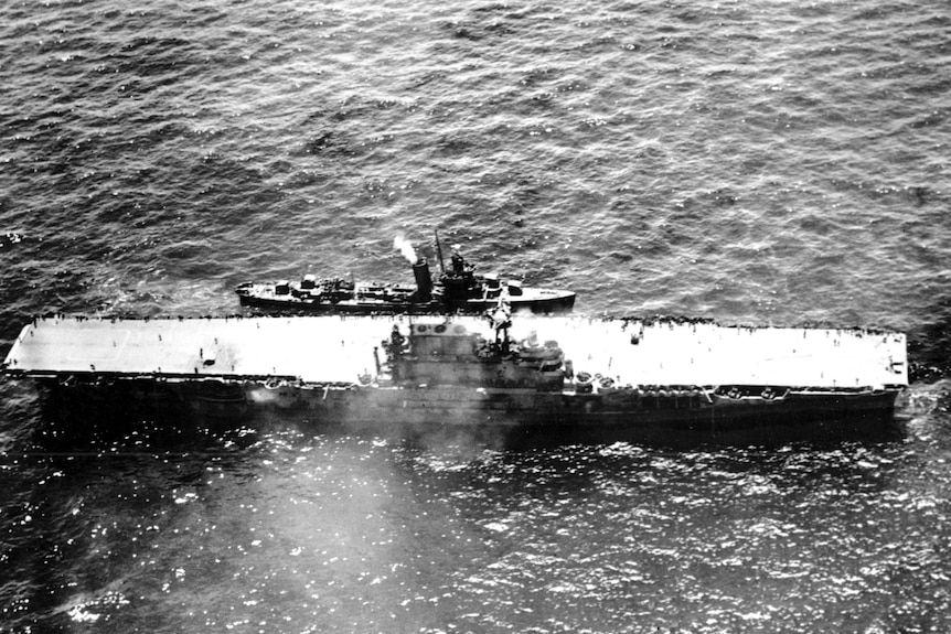 The stricken aircraft carrier USS Hornet lies dead in the waters after a morning attack by Japanese warplanes.