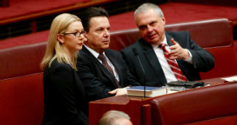 Skye Kakoschke-Moore, Nick Xenophon and Stirling Griff sit together in the senate