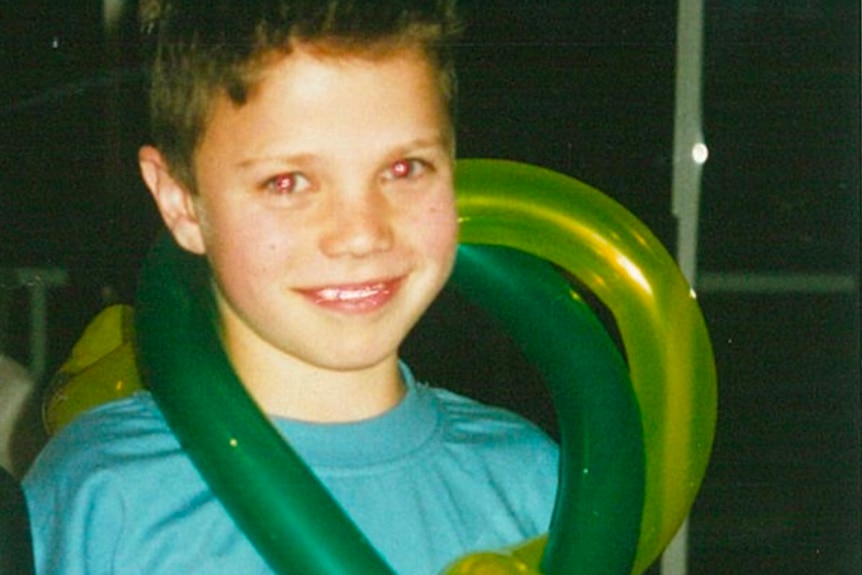 Matt Runnalls, pictured in grade 5, holding balloons.