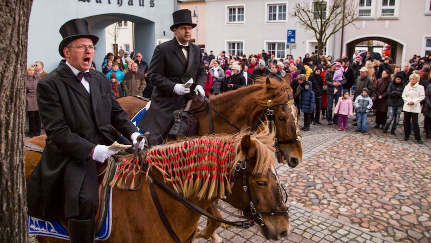 Easter riders sing as they parade on horseback in Wittichenau near Bautzen, Germany