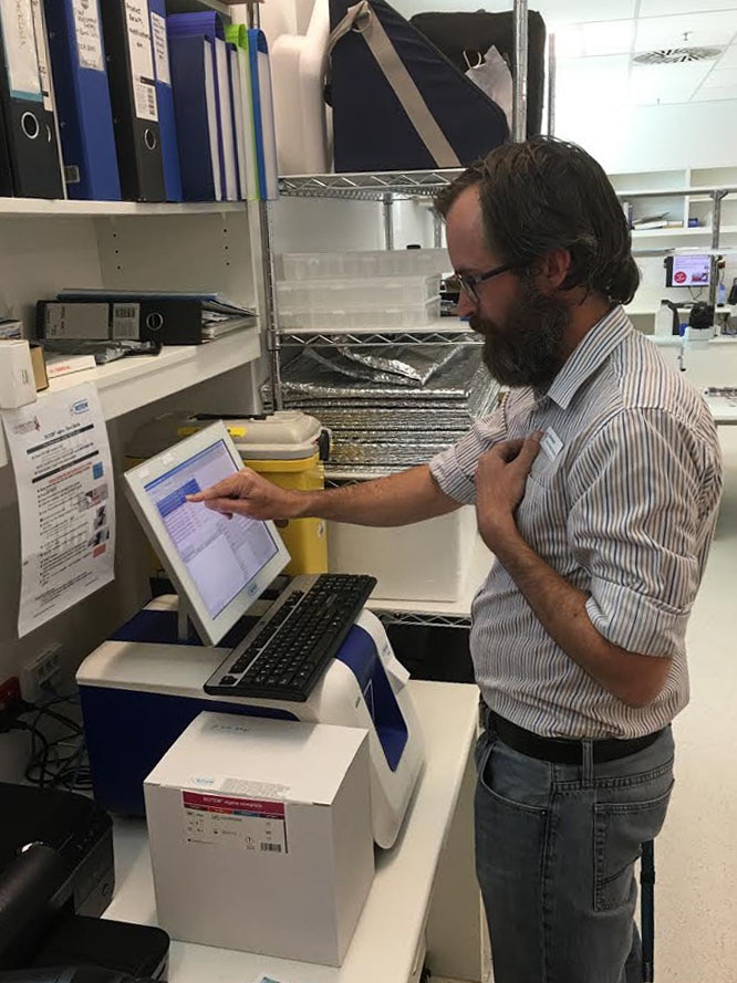 Scientist Ross Martin using the ROTEM blood machine.