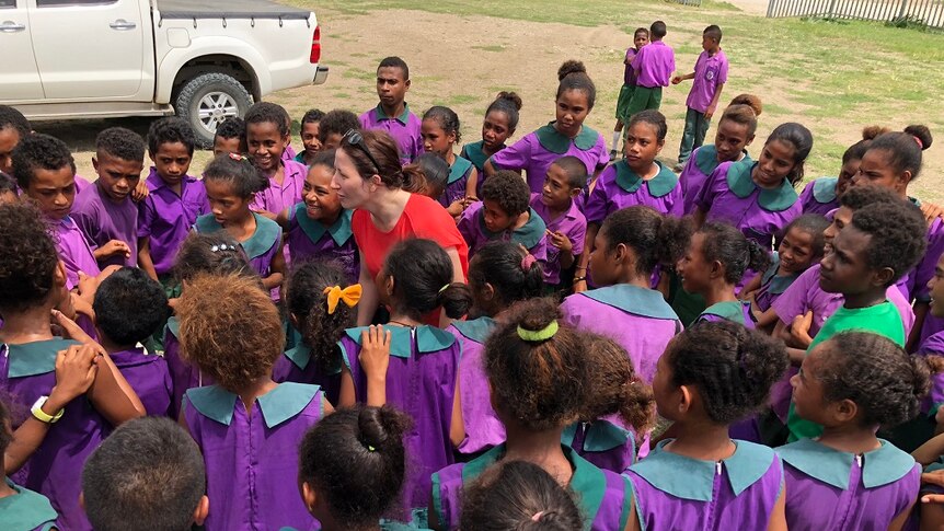 Mrs McDonald is surrounded by school children in PNG.