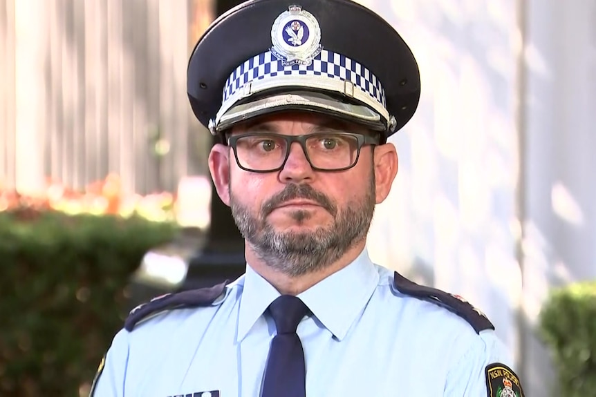a police man wearing glasses and looking