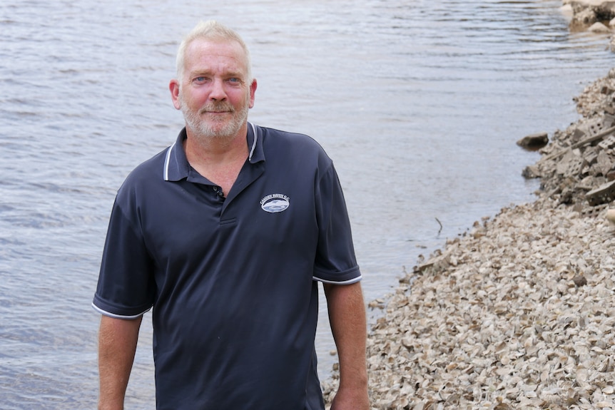 Oyster farmer David Smith in front of water.