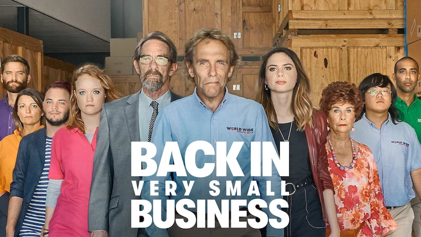 Characters of Back in Very Small Business standing in a v formation, staring seriously
