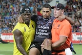 Ankle injury ... Greg Inglis is carried from the field (Getty Images: Bradley Kanaris)
