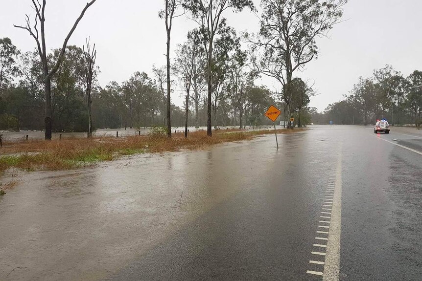 Water covers the Bruce Highway to traffic south of Miriam Vale in central Queensland