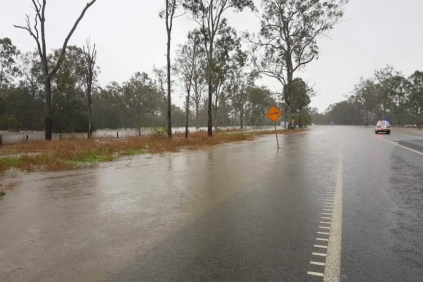 Water covers the Bruce Highway to traffic south of Miriam Vale in central Queensland