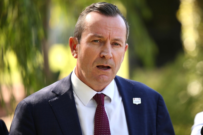 A head and shoulders shot of Mark McGowan with his mouth open talking during a media conference.