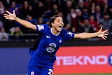 Sam Kerr runs and smiles and shouts with her arms outstretched after a Chelsea goal against Lyon in the Champions League.