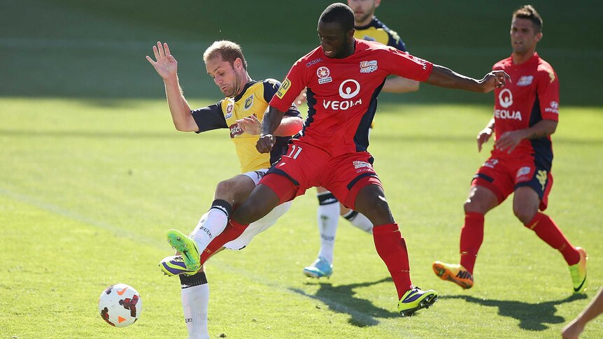 Adelaide's Bruce Djite scores the opening goal against the Central Coast Mariners.