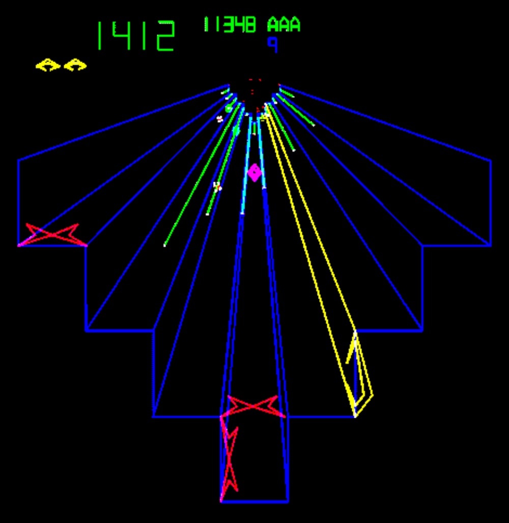 In a scene from a video game neon blue, green, yellow and red lines form a 3D-like abstract shape on black bacground.