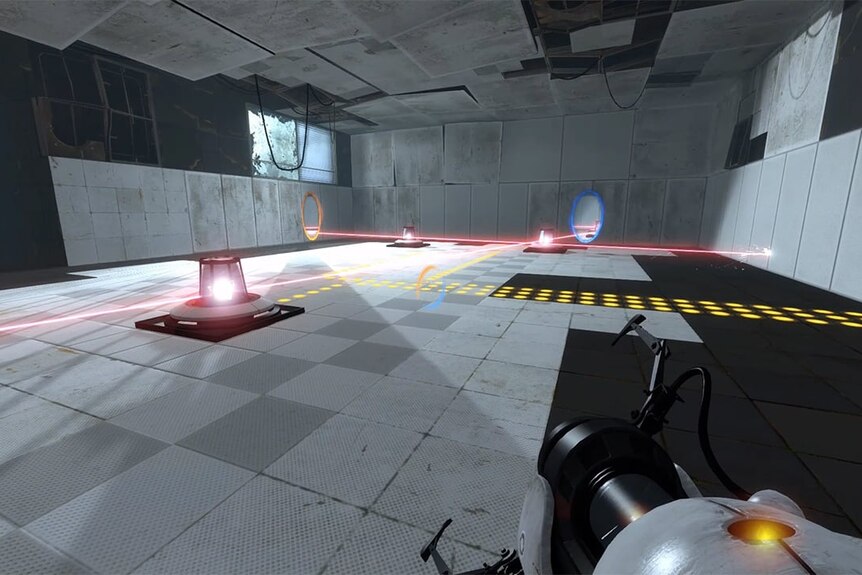 A first person perspective of a video game where the player is holding a portal gun and looking at a big room with lazers.