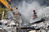 Rescue workers search for signs of life in the rubble of CTV building