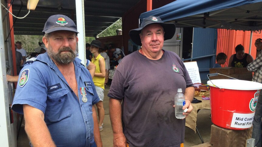 Hollisdale Rural Fire Service Captain Chris Roelandts, with another RFS member at the local community market.