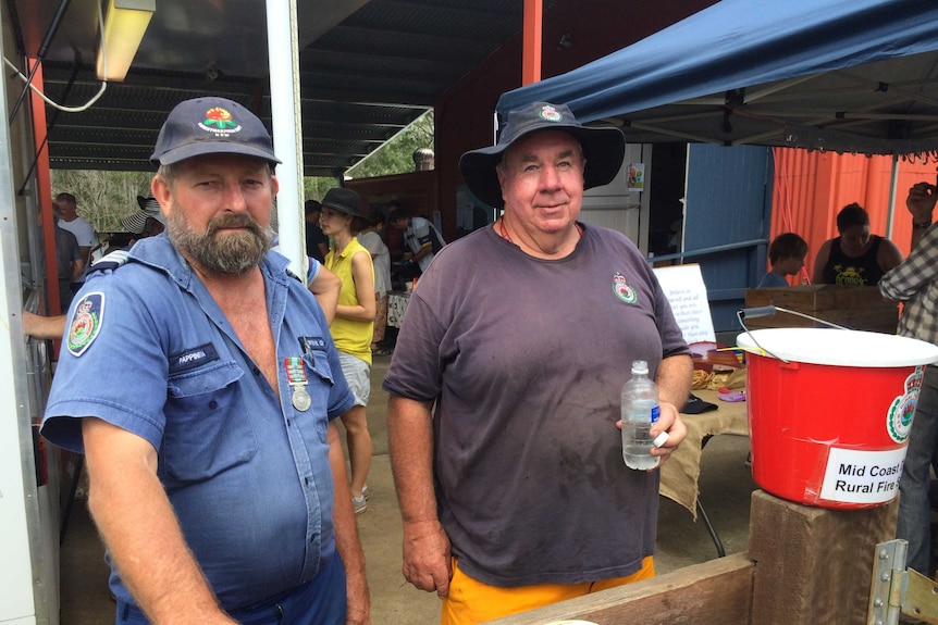 Hollisdale Rural Fire Service Captain Chris Roelandts, with another RFS member at the local community market.