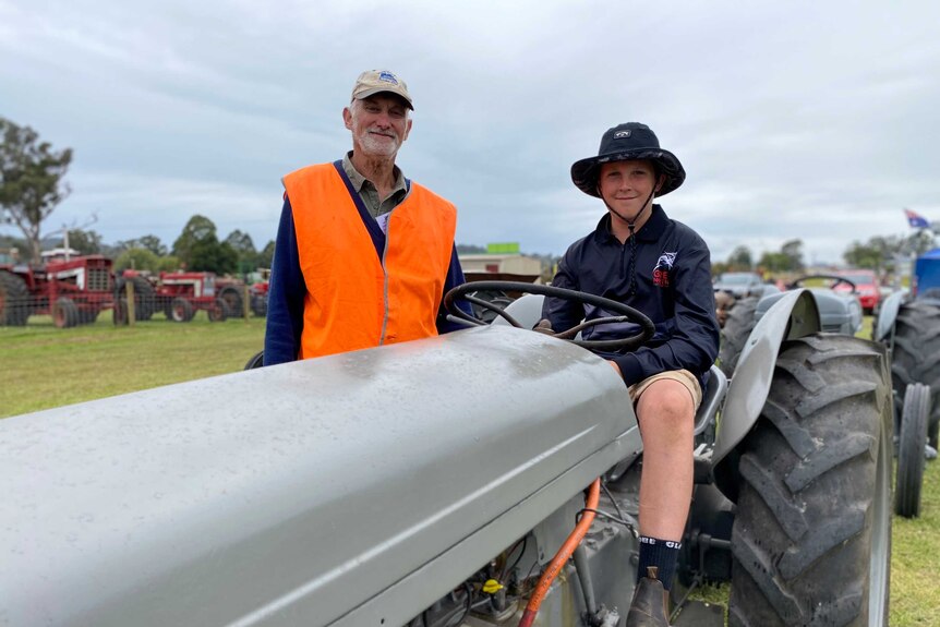 Gerard Gelston with his grandson Thomas, who is sitting a top an old Ferguson tractor.