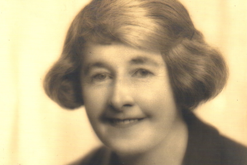 An old photo with a yellow background of a woman with light-coloured hair.