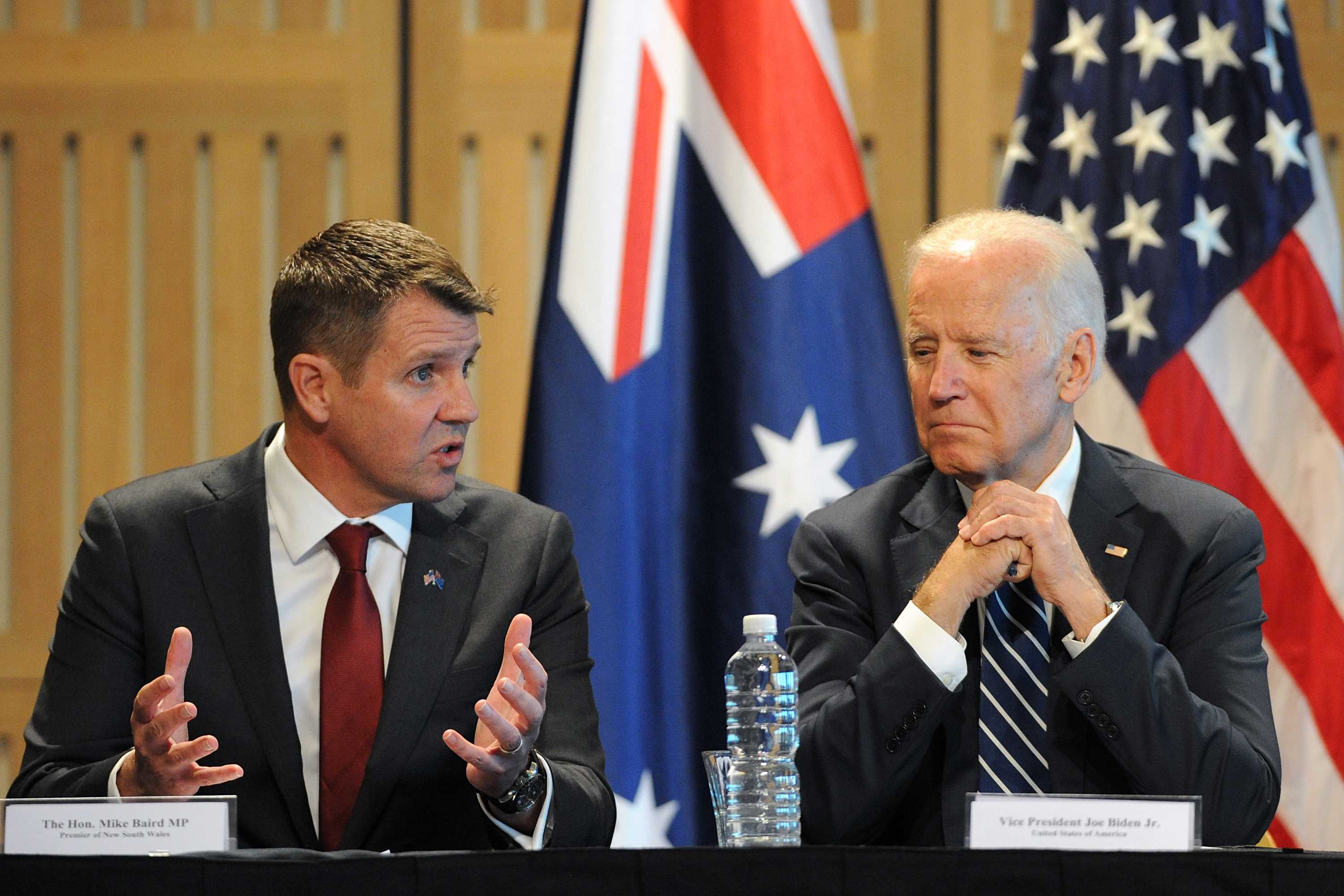 NSW Premier Mike Baird and US Vice President Joe Biden sitting at a table together.