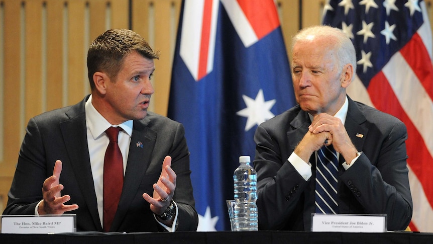 NSW Premier Mike Baird and US Vice President Joe Biden sitting at a table together.