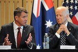 NSW Premier Mike Baird and US Vice President Joe Biden sitting at a table together.
