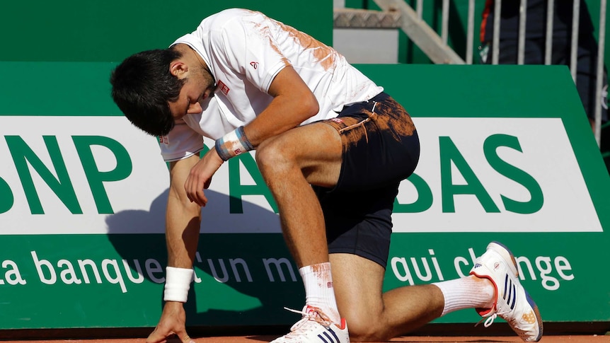 Serbia's Novak Djokovic falls during a quarter-final against David Goffin in Monte Carlo.