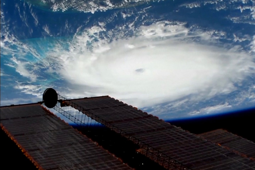 Hurricane Dorian's circular cloud formation and its eye stand out clearly against the Earth's blue oceans.
