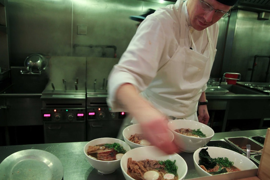 A chef preparing bowls of ramen at the Momofuku Noodle Bar in Manhattan