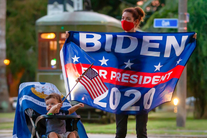 A mother and her son celebrate in New Orleans on Saturday, Nov. 7, 2020, after news that Joe Biden won the election.