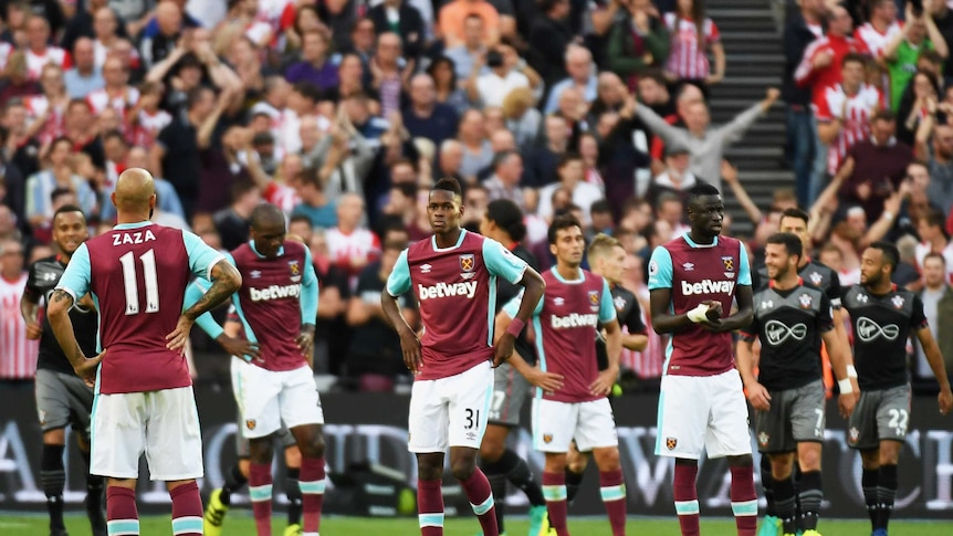 Dejected West Ham players look on as they concede a goal against Southampton on September 25, 2016.