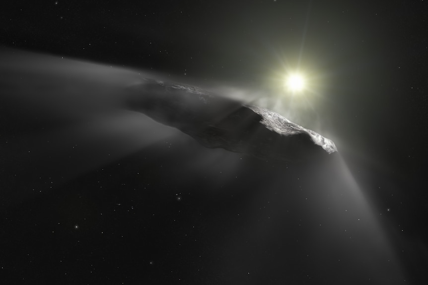 A cigar-shaped object appears in front of a bright star on a dark background somewhere in space.