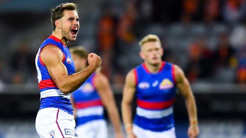 A Western Bulldogs AFL player pumps his fist as he celebrates a goal against the Giants.