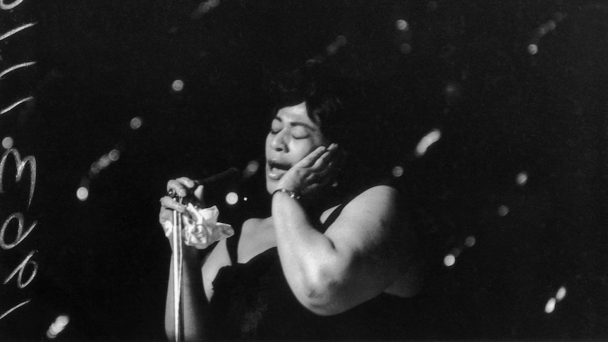 American jazz singer Ella Fitzgerald (1917 - 1996) singing at the Hammersmith Odeon
