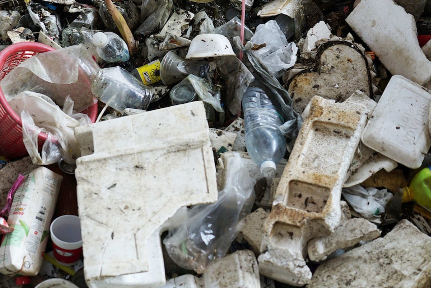 Plastic bottles and empty food containers are piled on top of one another.