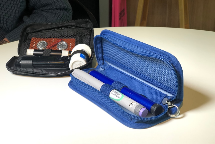 A glucometer kit sits on a white table.