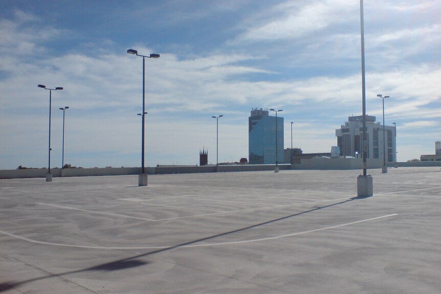 A clean empty city carpark with blue skies.