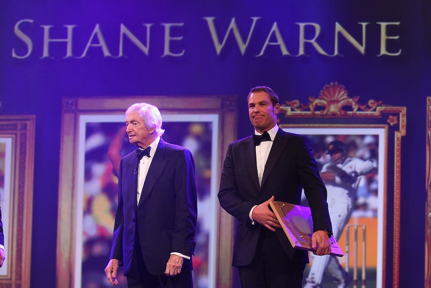 Immortalised ... spin king Shane Warne takes the stage with Richie Benaud.