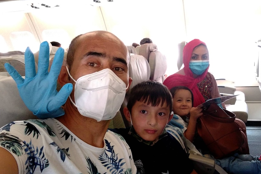 A family on board a plane as they flee Afghanistan.