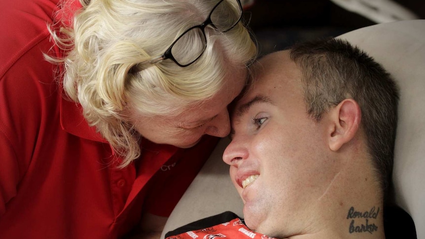 Betty Barker puts her forehead against Chrys Barker's forehead