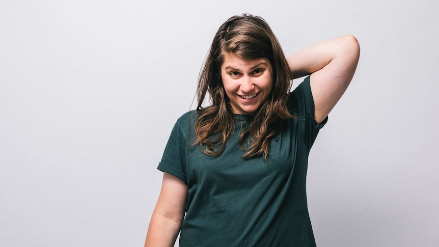 Alex Lahey stands in a green t-shirt