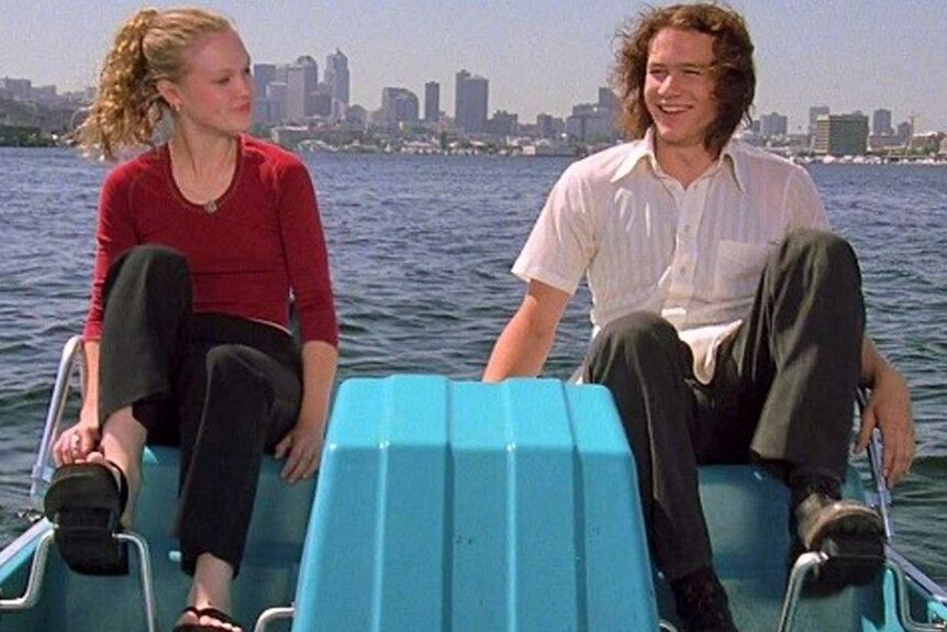 Kat and Patrick from 10 Things I Hate About You paddling in the water; he wears Dr Martens