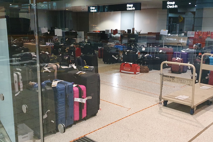 Suitcases and luggage sitting on the floor at the Qantas group check in area