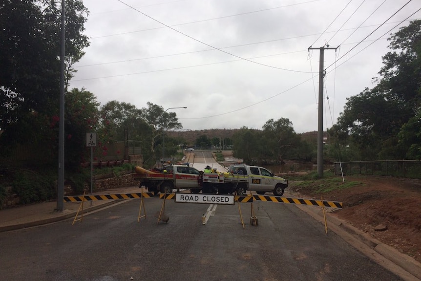 Emergency services search for a man in the flooded Leichhardt River