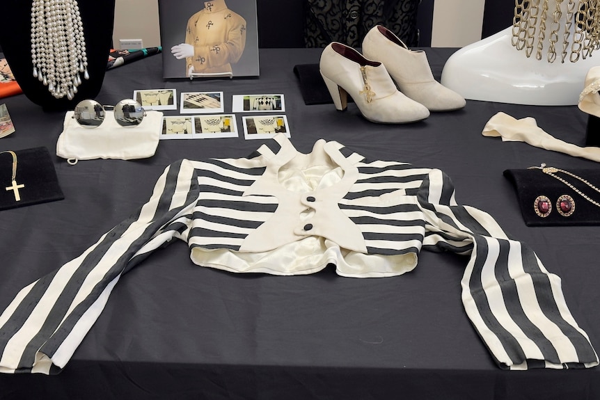 A black and white striped shirt owned by Prince is displayed among memorabilia.