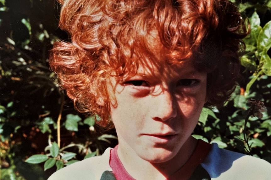 A young boy with flaming red hair